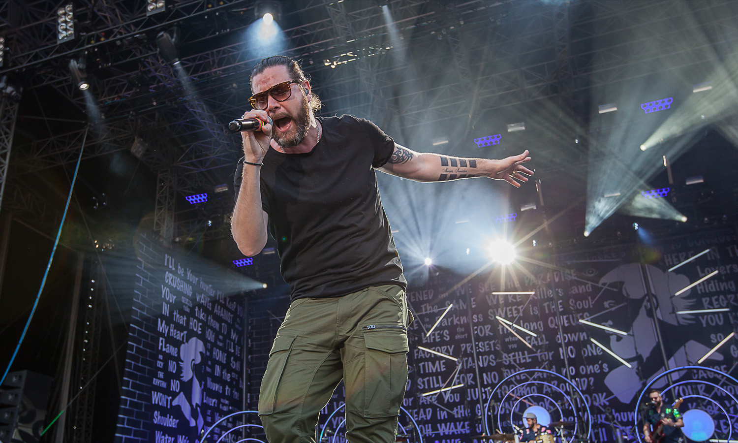 Rea Garvey steht auf der großen Open-Air-Bühne beim Hessentag 2019 in Bad Hersfeld und singt vor einer jubelnden Menschenmenge im bunten Scheinwerferlicht.